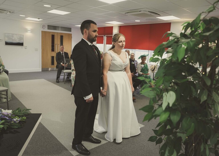A bride and groom during their wedding ceremony at Cambridge Registry Office photographed by Suffolk Wedding Photographer Hayley Denston Photography