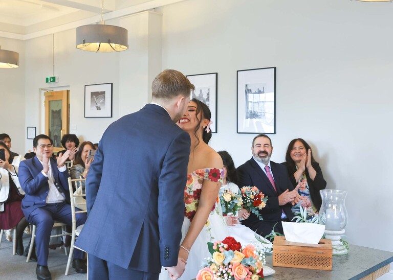 A bride and groom kissing on their wedding day as they have just said I do during their wedding ceremony at Bury St Edmunds Registry Office photographed by Suffolk Wedding Photographer Hayley Denston Photography