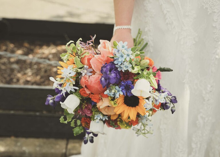 A bright multicoloured bridal bouquet on a wedding day at Venue 16 captured by suffolk wedding photographer Hayley Denston Photography