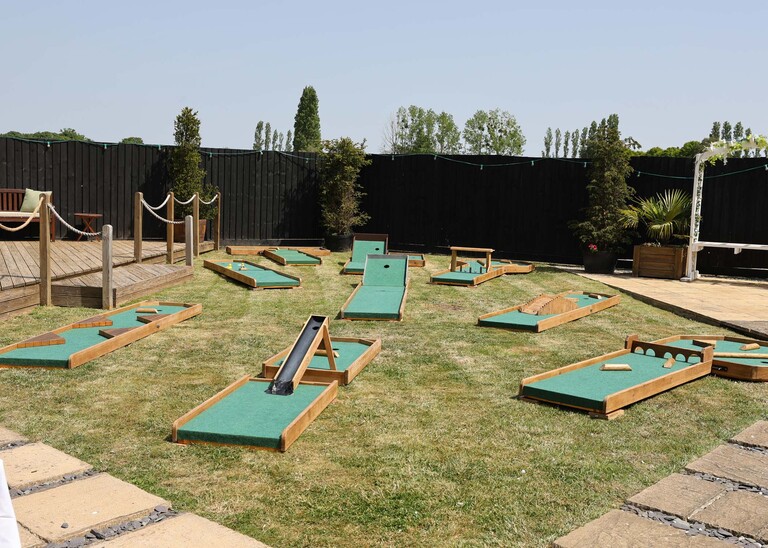 A mini golf course set up for a wedding reception on a wedding day at Venue 16 captured by suffolk wedding photographer Hayley Denston Photography