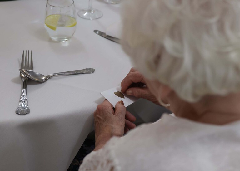 A guest doing a scratch card on a wedding day at Venue 16 captured by suffolk wedding photographer Hayley Denston Photography