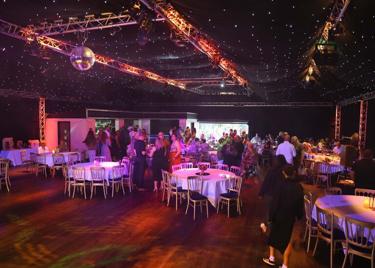A pink and purple glowing evening wedding reception on a wedding day at Venue 16 captured by suffolk wedding photographer Hayley Denston Photography