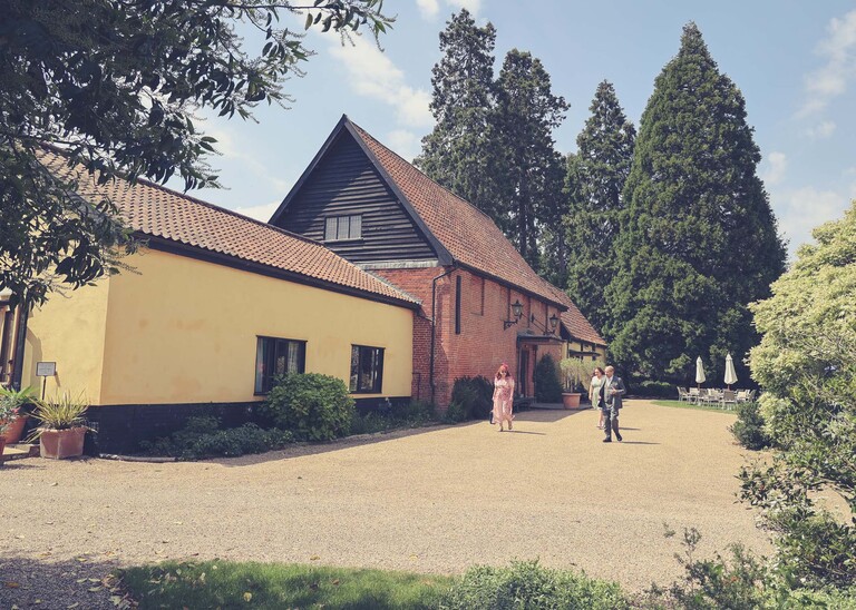 Haughley Park barn wedding venue barn on a sunny spring day on a wedding day at Haughley Park Barn photographed by suffolk wedding photographer Hayley Denston Photography