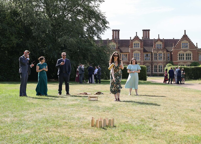 Guests playing garden games on a wedding day at Haughley Park Barn photographed by suffolk wedding photographer Hayley Denston Photography