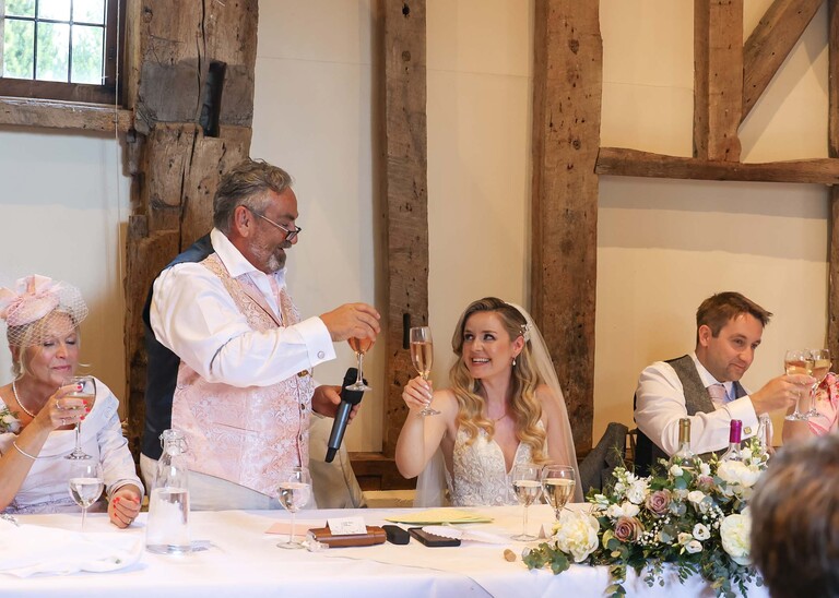 A father of the bride giving his speech and toasting the bride on a wedding day at Haughley Park Barn photographed by suffolk wedding photographer Hayley Denston Photography