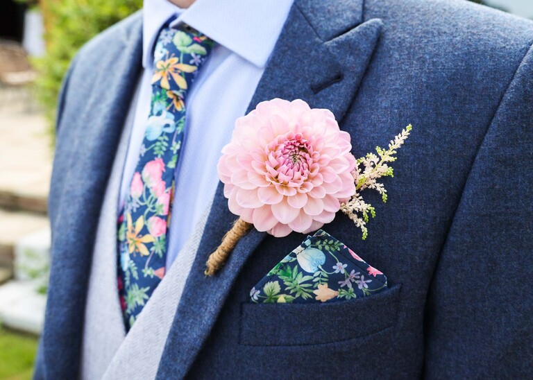 A pink pompom dahlia buttonhole on a wedding day at Little Green Wedding Barn photographed by suffolk wedding photographer Hayley Denston Photography