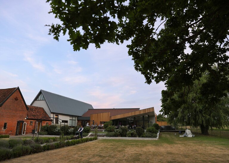 A wedding venue at sunset on a wedding day at Little Green Wedding Barn photographed by suffolk wedding photographer Hayley Denston Photography