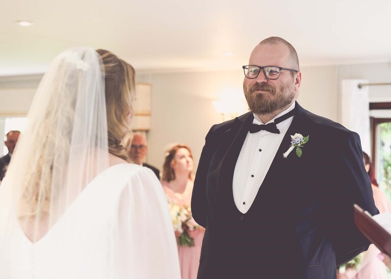 A groom and bride during a wedding ceremony  on a wedding day at Hungarian Hall Estate photographed by suffolk wedding photographer Hayley Denston Photography