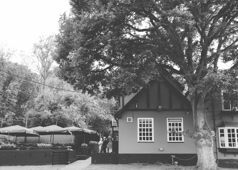 A black and white photo of a bride and groom at an evening wedding reception at the Unruly Pig in Suffolk captured by Suffolk Wedding Photographer Hayley Denston Photography