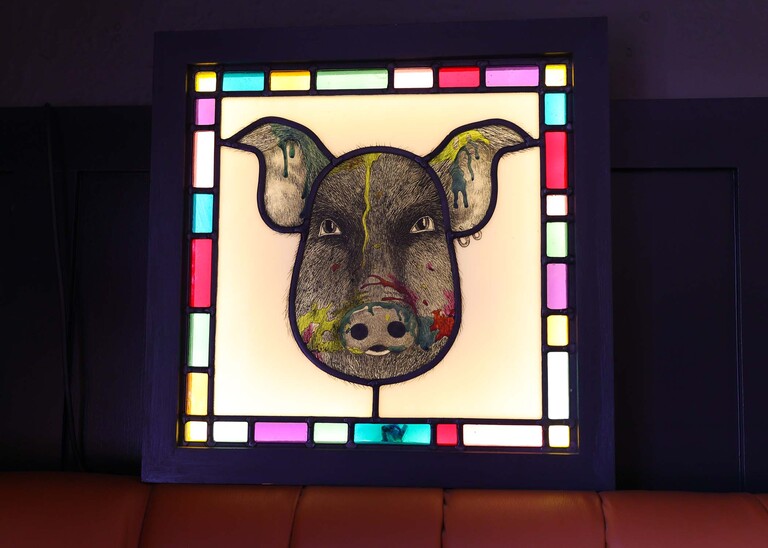 The unruly pig stained glass at an evening wedding reception at the Unruly Pig in Suffolk captured by Suffolk Wedding Photographer Hayley Denston Photography